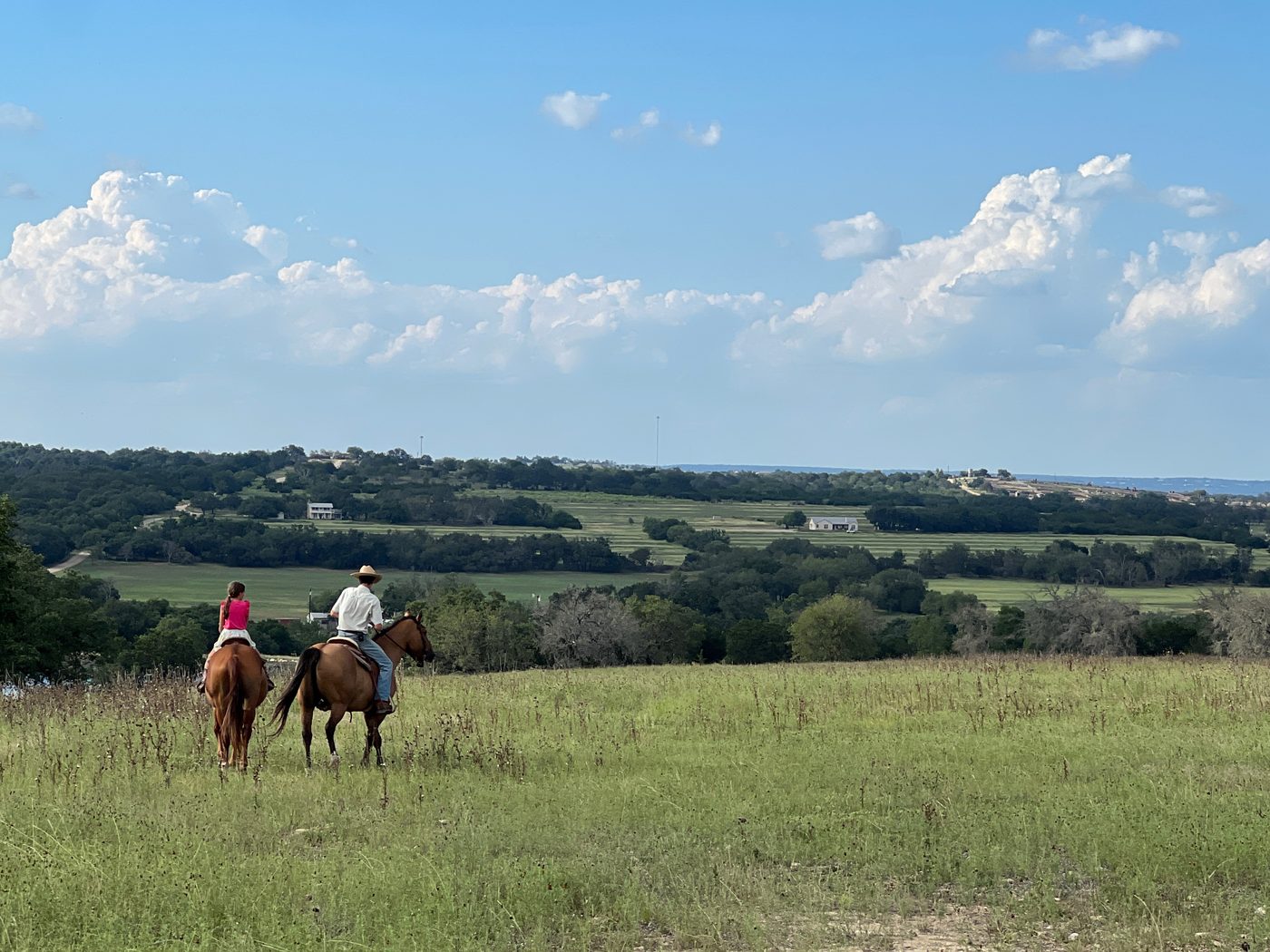 Riding horseback across a Hill Country pasture