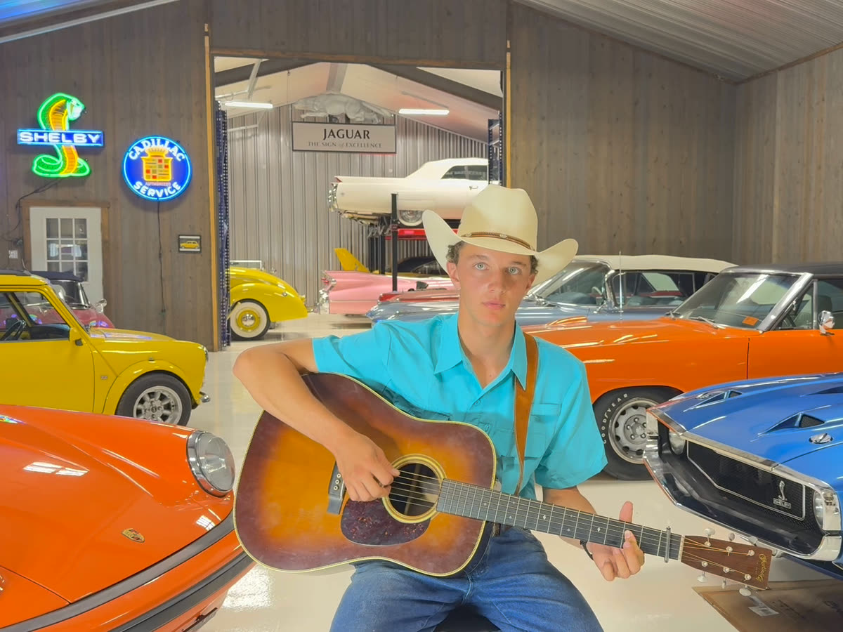 Matthew Underwood playing his dark sunburst Martin acoustic guitar